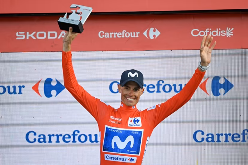 Overall race leader Team Movistar's Spanish rider Enric Mas celebrates retaining the race lead on the podium after the 14th stage of the Vuelta a Espana 2026 cycling tour, a 154,5 km race between Jaen and Sierra de la Pandera, on September 5, 2026. JORGE GUERRERO / AFP