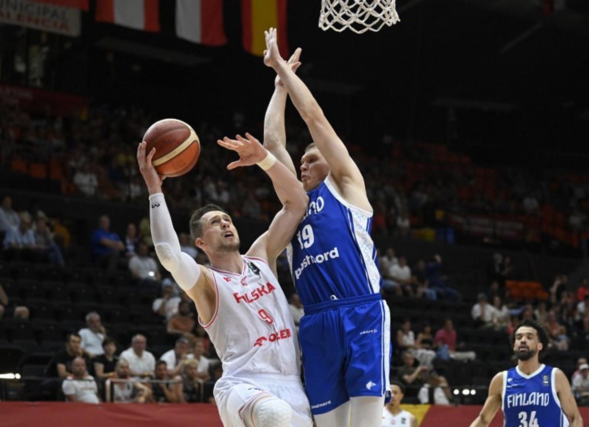 Poland's forward #09 Mateusz Ponitka vies for the ball with Finland's forward #19 Elias Valtonen during the 2024 FIBA Olympic Qualifying Tournament basketball match between Poland and Finland in Valencia, on July 4, 2024. JOSE JORDAN / AFP