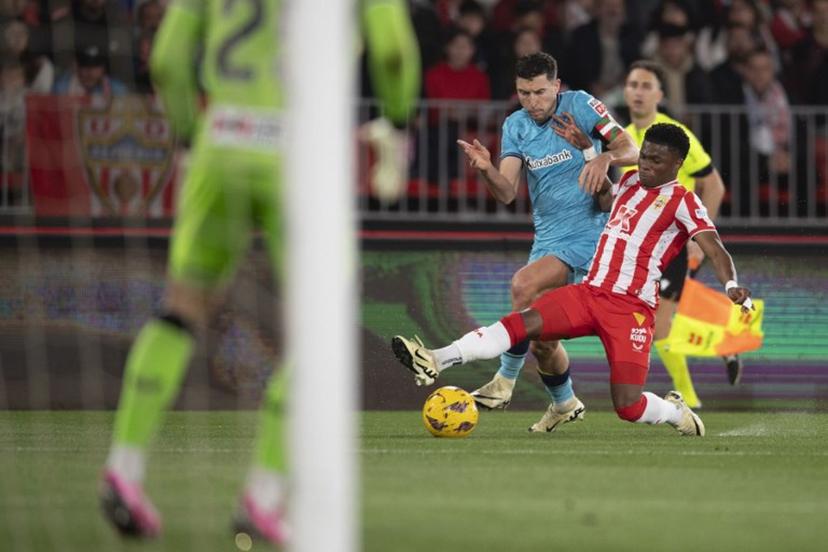 Athletic Bilbao's Spanish defender #18 Oscar De Marcos (L) fights for the ball with Almeria's Belgian forward #07 Largie Ramazani during the Spanish league football match between UD Almeria and Athletic Club Bilbao at the Municipal Stadium of the Mediterranean Games in Almeria on February 12, 2024. JORGE GUERRERO / AFP