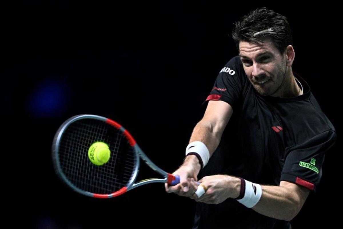 Britain's Cameron Norrie plays a backhand return to Monaco's Valentin Vacherot during their men's singles match on day four of the Paris ATP Masters 1000 tennis tournament at the Paris La Défense Arena in Nanterre, on the outskirts of Paris, on October 30, 2025. JULIEN DE ROSA / AFP