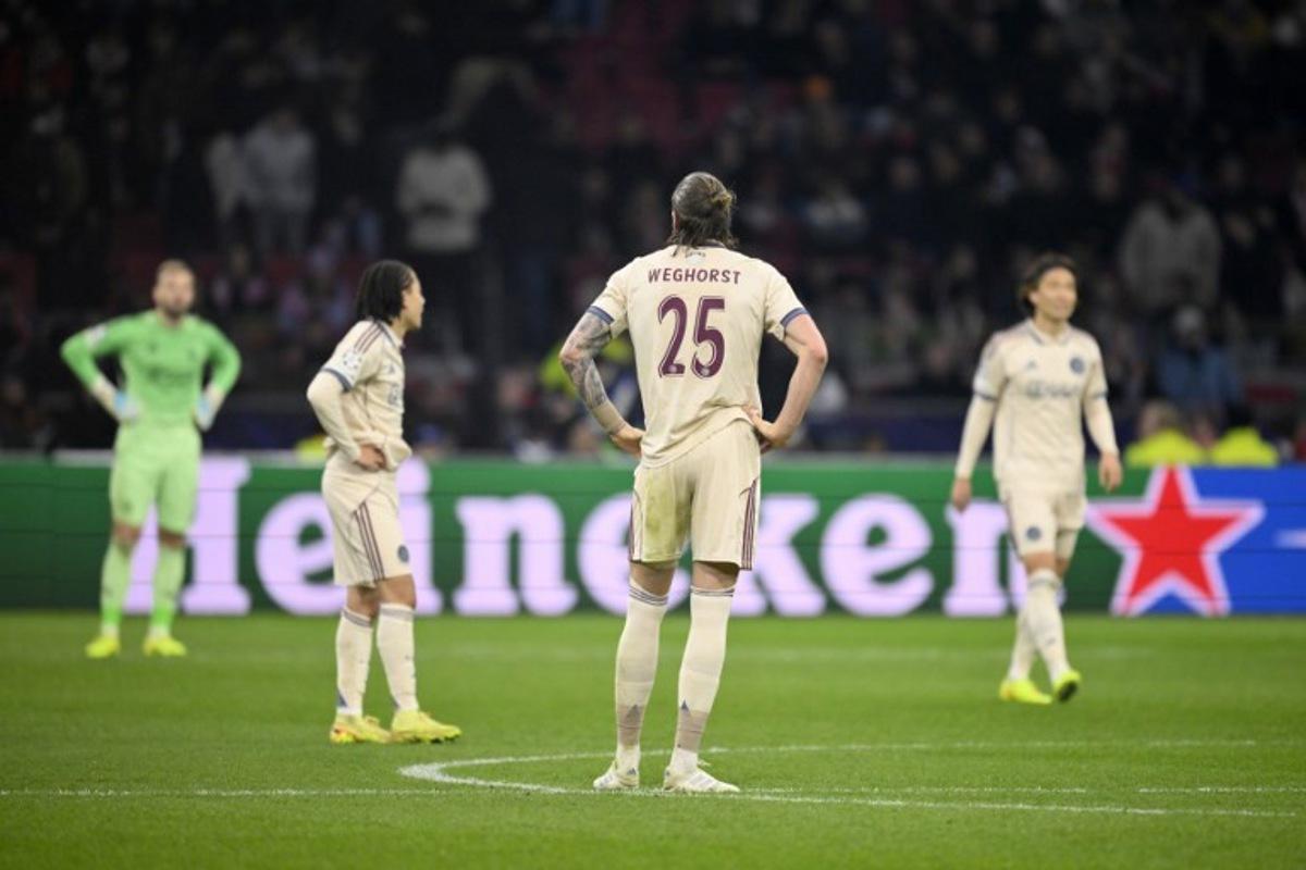 Ajax's Dutch forward #25 Wout Weghorst and team mates react after conceding a goal during the UEFA Champions League, league phase day 5, football match between Ajax and Benfica at the Johan-Cruijff ArenA in Amsterdam on November 25, 2025. JOHN THYS / AFP