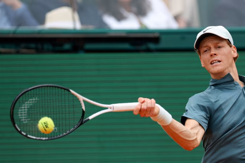 Italy's Jannik Sinner plays a forehand return to Spain's Carlos Alcaraz during the Monte Carlo ATP Masters Series Tournament final tennis match on Court Rainier III at the Monte-Carlo Country Club in Roquebrune-Cap-Martin, south-eastern France on April 12, 2026. Valery HACHE / AFP