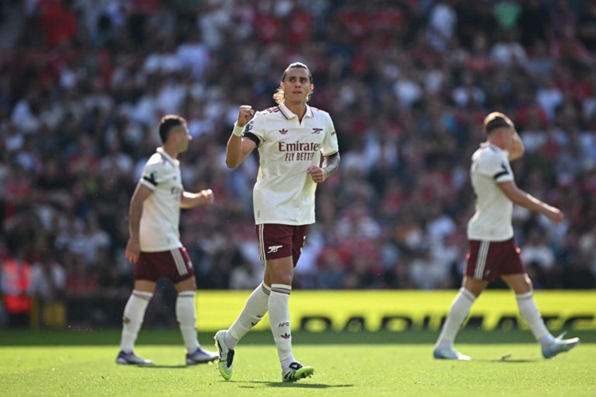 Arsenal's Italian defender #33 Riccardo Calafiori (C) celebrates scoring the opening goal during the English Premier League football match between Manchester United and Arsenal at Old Trafford in Manchester, north west England, on August 17, 2025. Paul ELLIS / AFP
