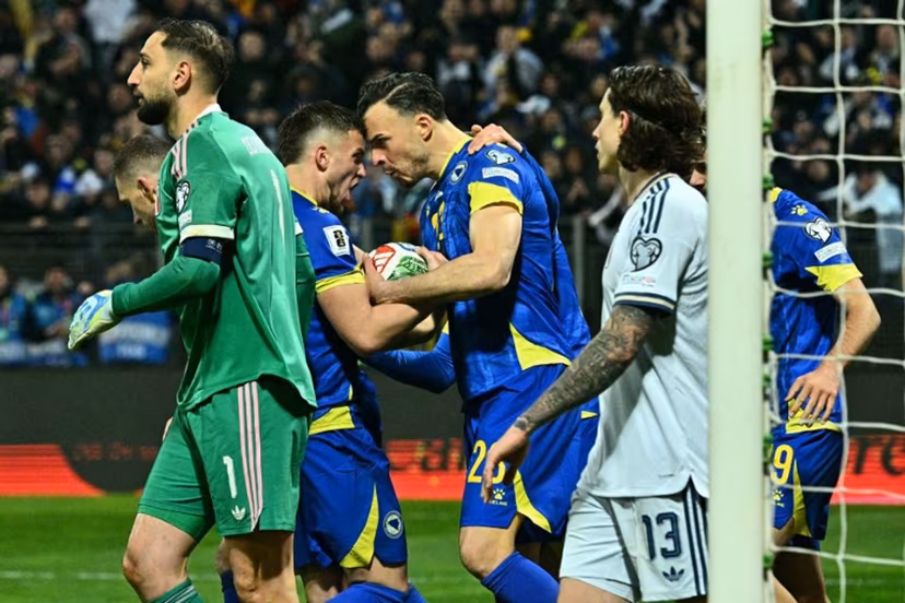 Bosnia-Herzegovina's forward #23 Haris Tabakovic (C) celebrates with teammates after scoring during the FIFA World Cup 2026 European qualification final football match between Bosnia-Herzegovina and Italy at the Bilino-Polje stadium in Zenica on March 31, 2026. Elvis BARUKCIC / AFP