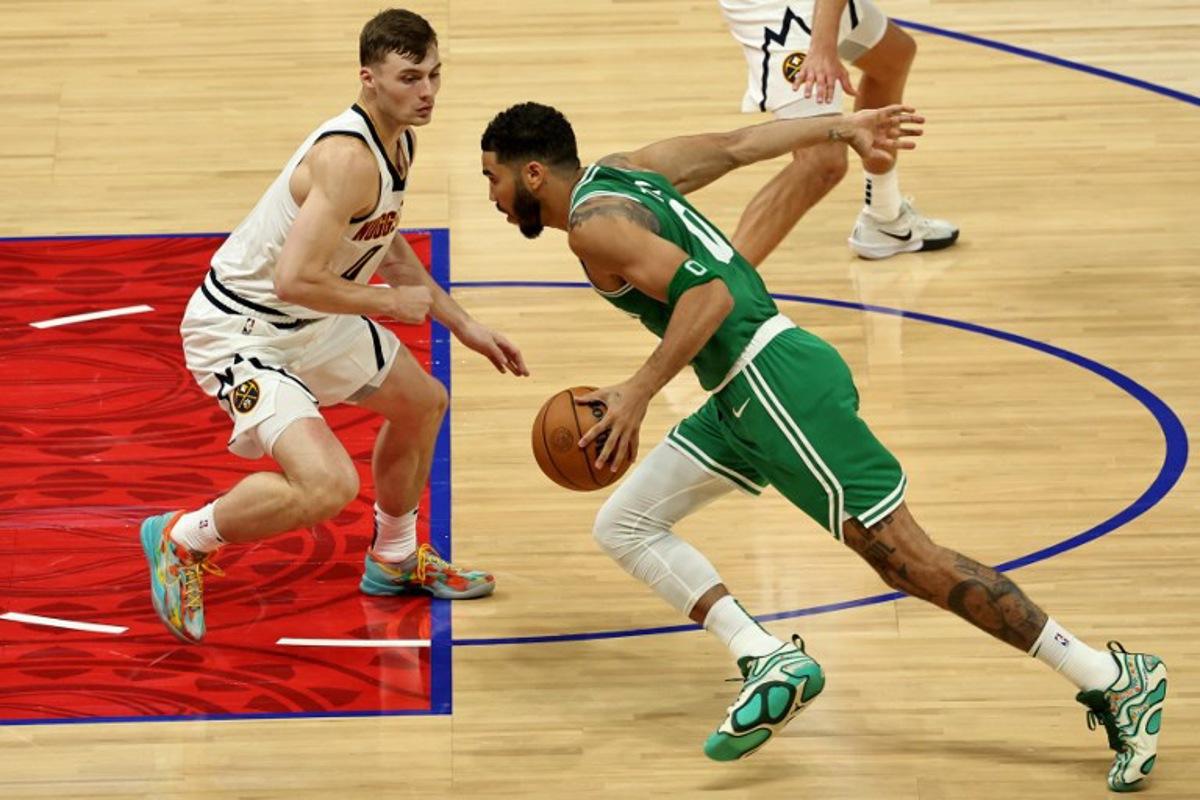 Denver Nuggets' forward #0 Christian Braun fights for the ball with Boston Celtics' forward #0 Jayson Tatum during the NBA Preseason game between the Denver Nuggets and the Boston Celtics at the Etihad Arena in Abu Dhabi on October 4, 2024. Fadel Senna / AFP