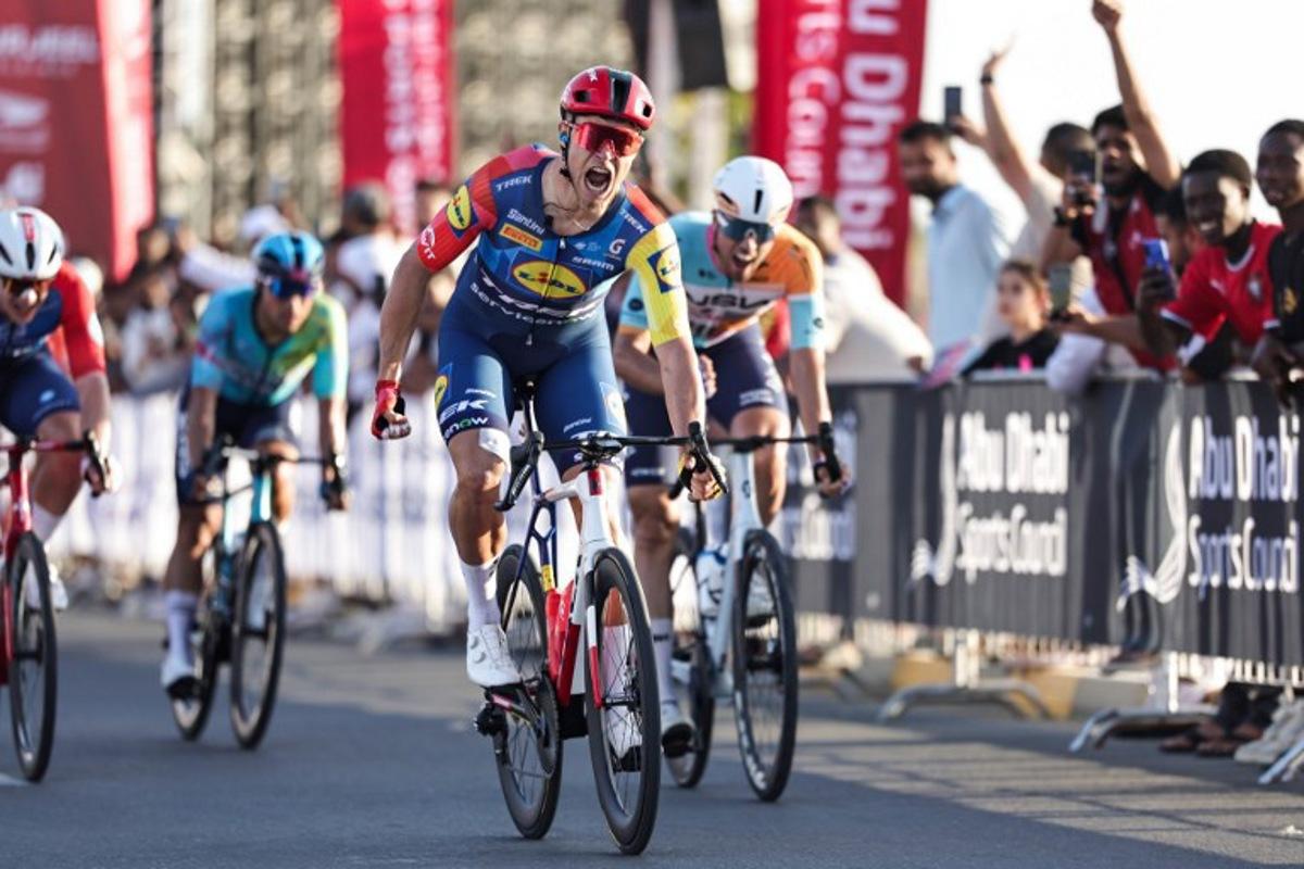 Lidl-Trek's Italian rider Jonathan Milan reacts after crossing the finish line first during the fourth stage of the UAE Tour cycling event in al-Fujairah on February 19, 2026. Fadel SENNA / AFP