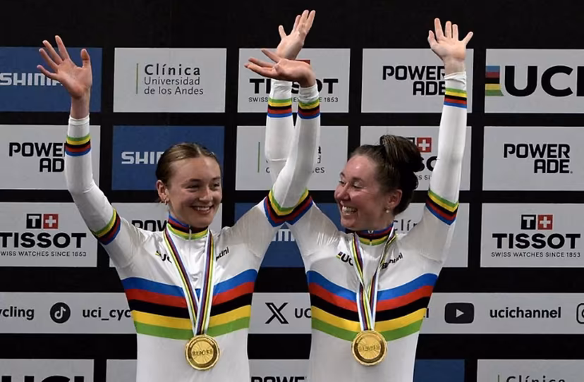 Great Britain's #19 Madelaine Leech and Great Britain's #51 KAtie Archibald pose with their gold medals during the women's madison 30km event award ceremony at the 2025 UCI Track World Championships, in the Penalolen Velodrome in Santiago, on October 25, 2025. Rodrigo ARANGUA / AFP