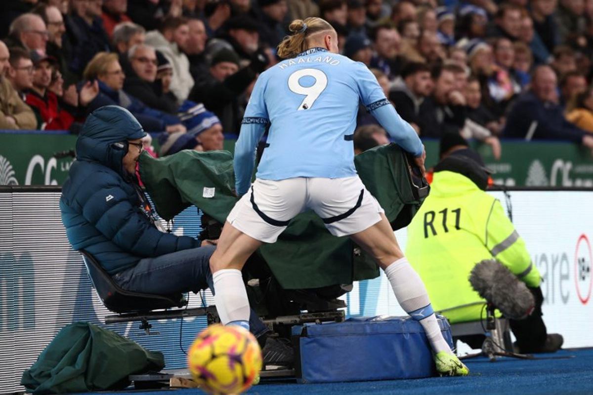 Manchester City's Norwegian striker #09 Erling Haaland runs into a television camera during the English Premier League football match between Leicester City and Manchester City at King Power Stadium in Leicester, central England on December 29, 2024. Darren Staples / AFP