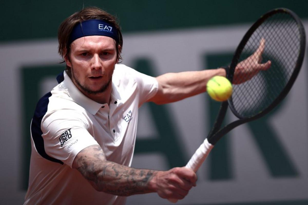 Kazakhstan's Alexander Bublik plays a backhand return to Australia's Alex De Minaur during their men's singles match on day 5 of the French Open tennis tournament at the Roland-Garros Complex in Paris on May 29, 2025. Anne-Christine POUJOULAT / AFP