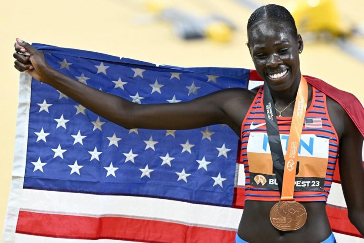USA's bronze medallist Athing Mu celebrates with her medal and national flag after the women's 800m final during the World Athletics Championships at the National Athletics Centre in Budapest on August 27, 2023. Attila KISBENEDEK / AFP