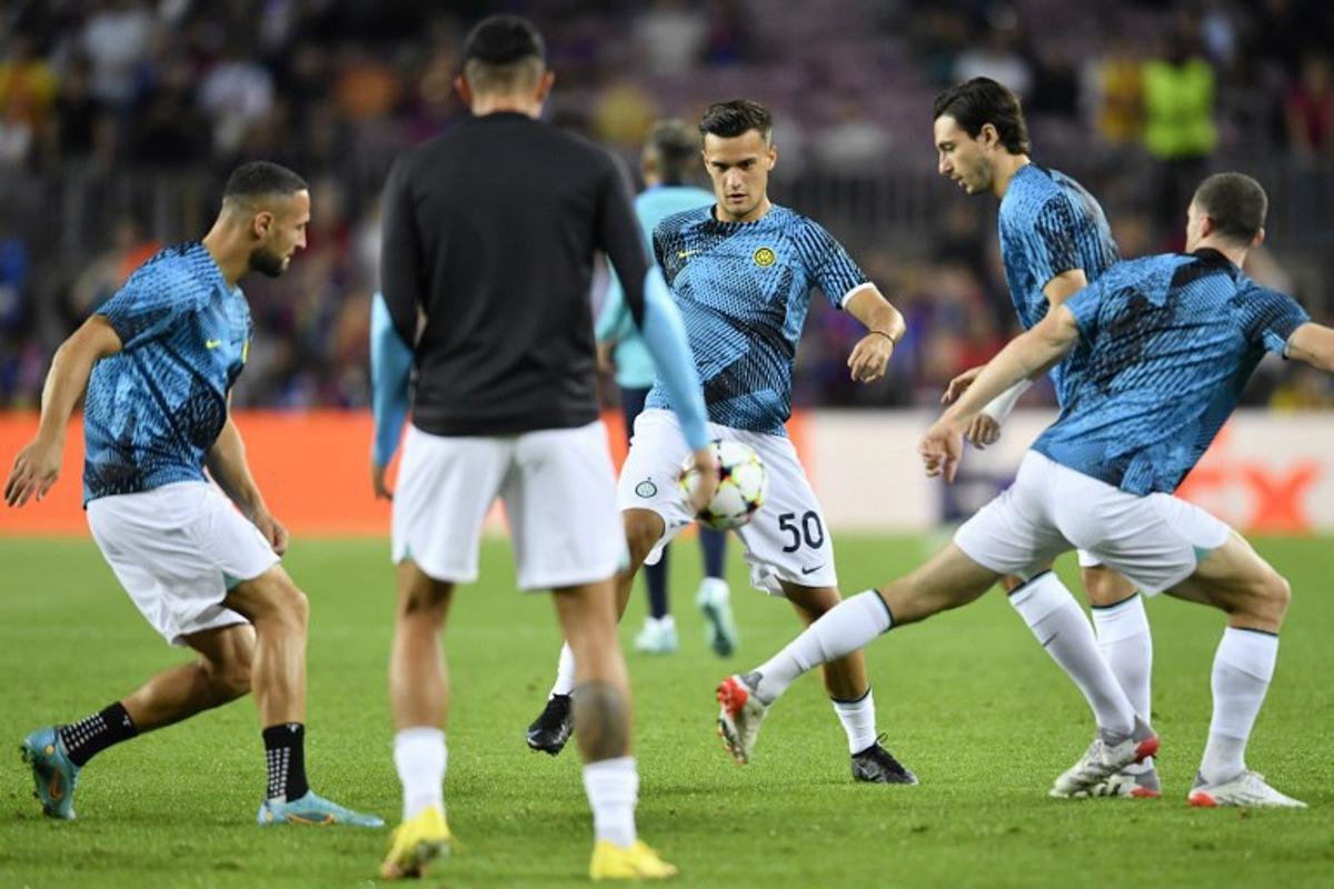 Inter Milan's Serbian midfielder Aleksandar Stankovic (C) warms up with teammates before the UEFA Champions League 1st round, group C, football match between FC Barcelona and Inter Milan at the Camp Nou stadium in Barcelona on October 12, 2022. Pau BARRENA / AFP