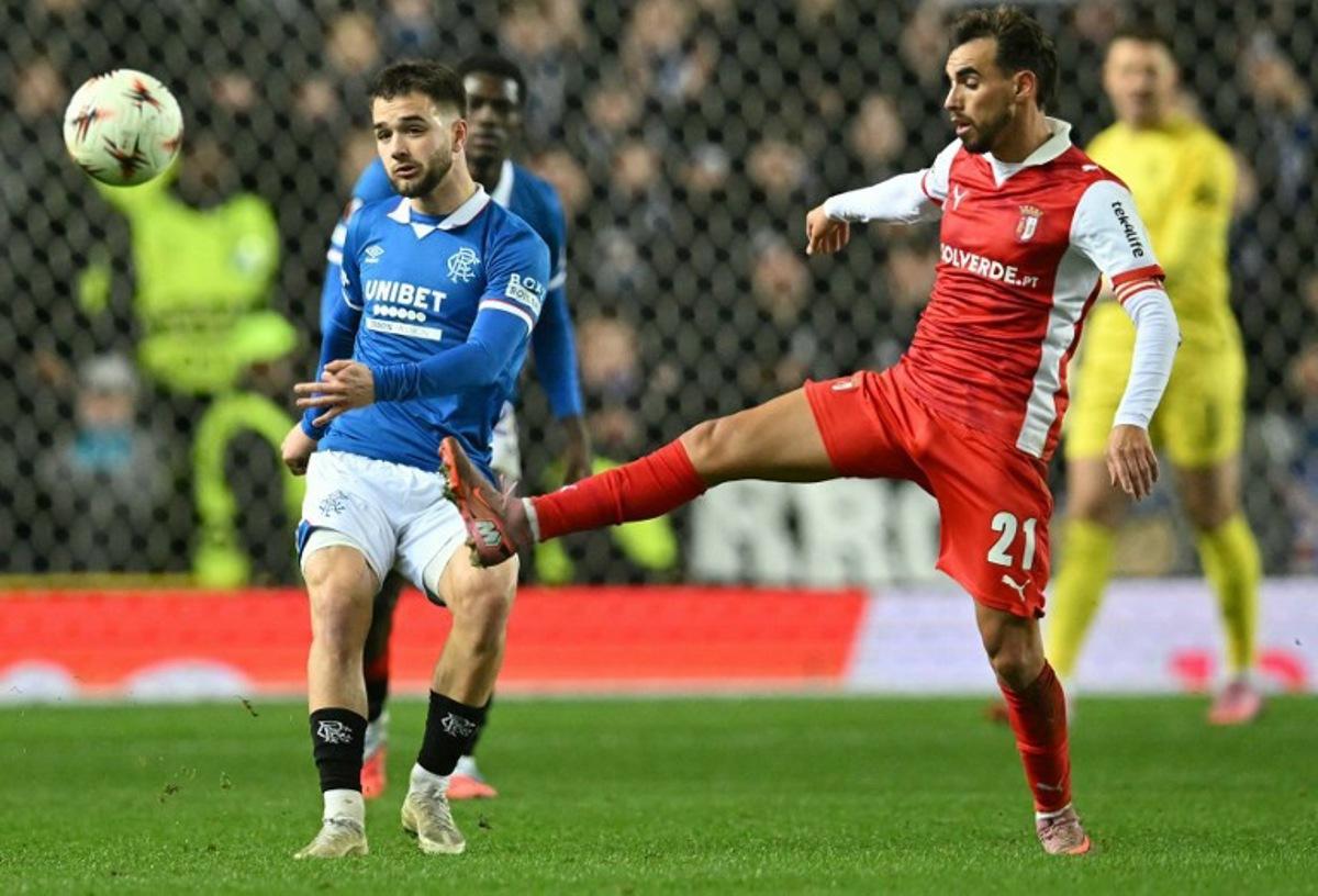 Sporting Braga's Portuguese midfielder #21 Ricardo Horta (R) vies with Rangers' Belgian midfielder #43 Nicolas Raskin during the UEFA Europa League league-stage football match between Rangers and CS Braga at the Ibrox Stadium in Glasgow on November 27, 2025. ANDY BUCHANAN / AFP