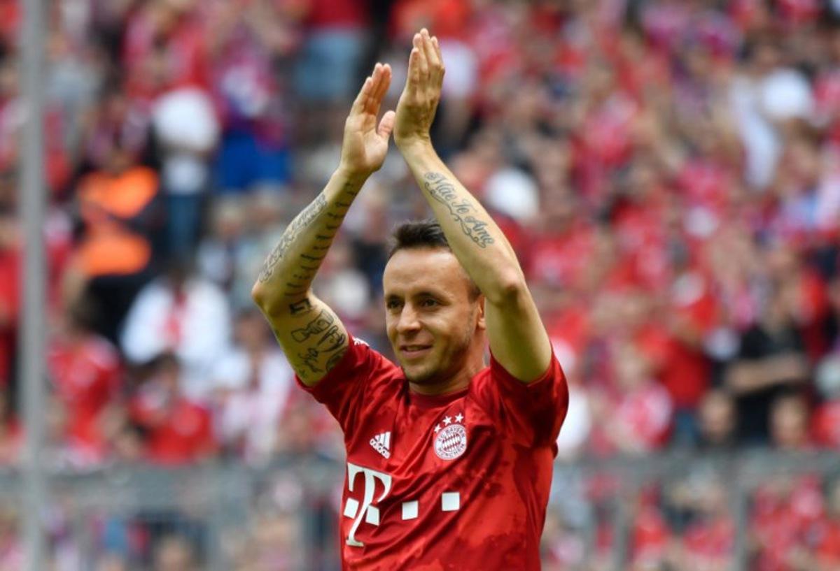 (FILES) Bayern Munich's Brazilian defender Rafinha cheers after his last match with Bayern after the German First division Bundesliga football match FC Bayern Munich v Eintracht Frankfurt in Munich, southern Germany, on May 18, 2019. Rafinha announced at the age of 39 his retirement as a footballer on July 21, 2025. The Brazilian player won the Champions League with Bayern Munich and the Copa Libertadores with Flamengo. John MACDOUGALL / AFP