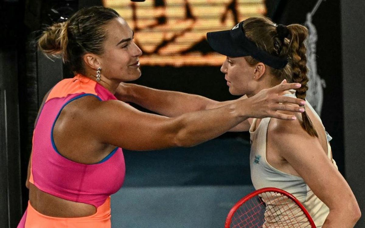 Kazakhstan's Elena Rybakina (R) greets Belarus' Aryna Sabalenka after her victory in their women's singles final match on day fourteen of the Australian Open tennis tournament in Melbourne on January 31, 2026. WILLIAM WEST / AFP