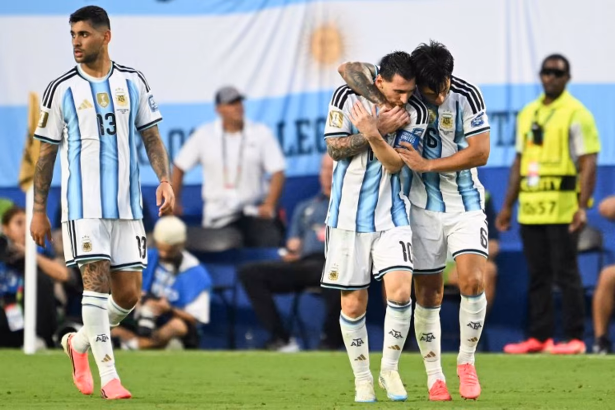 Argentina's defender #06 Lisandro Martinez celebrates with teammate Argentina's forward #10 Lionel Messi scoring his team's second goal next to Argentina's defender #13 Cristian Romero during the 2026 World Cup round of 32 football match between Argentina and Cape Verde at the Miami Stadium in Miami Gardens on July 3, 2026. ROBERTO SCHMIDT / AFP