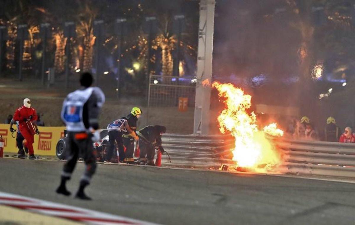 A steward reacts as officials put out a fire on Haas F1's French driver Romain Grosjean car following a crash during the Bahrain Formula One Grand Prix at the Bahrain International Circuit in the city of Sakhir on November 29, 2020. TOLGA BOZOGLU / POOL / AFP