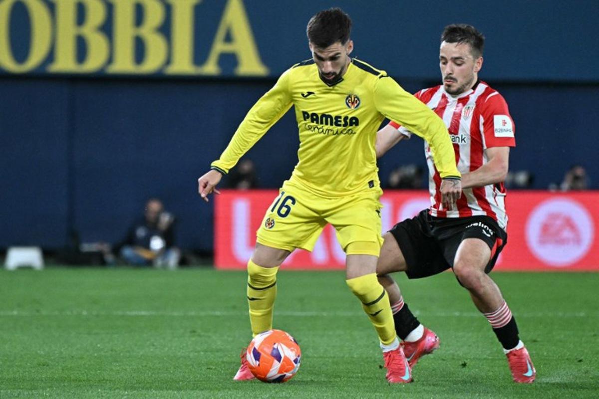 Villarreal's Spanish midfielder #16 Alex Baena and Athletic Bilbao's Spanish defender #02 Andoni Gorosabel vie for the ball during the Spanish league football match between Villarreal CF and Athletic Club Bilbao at La Ceramica stadium in Vila-real on April 6, 2025. JOSE JORDAN / AFP