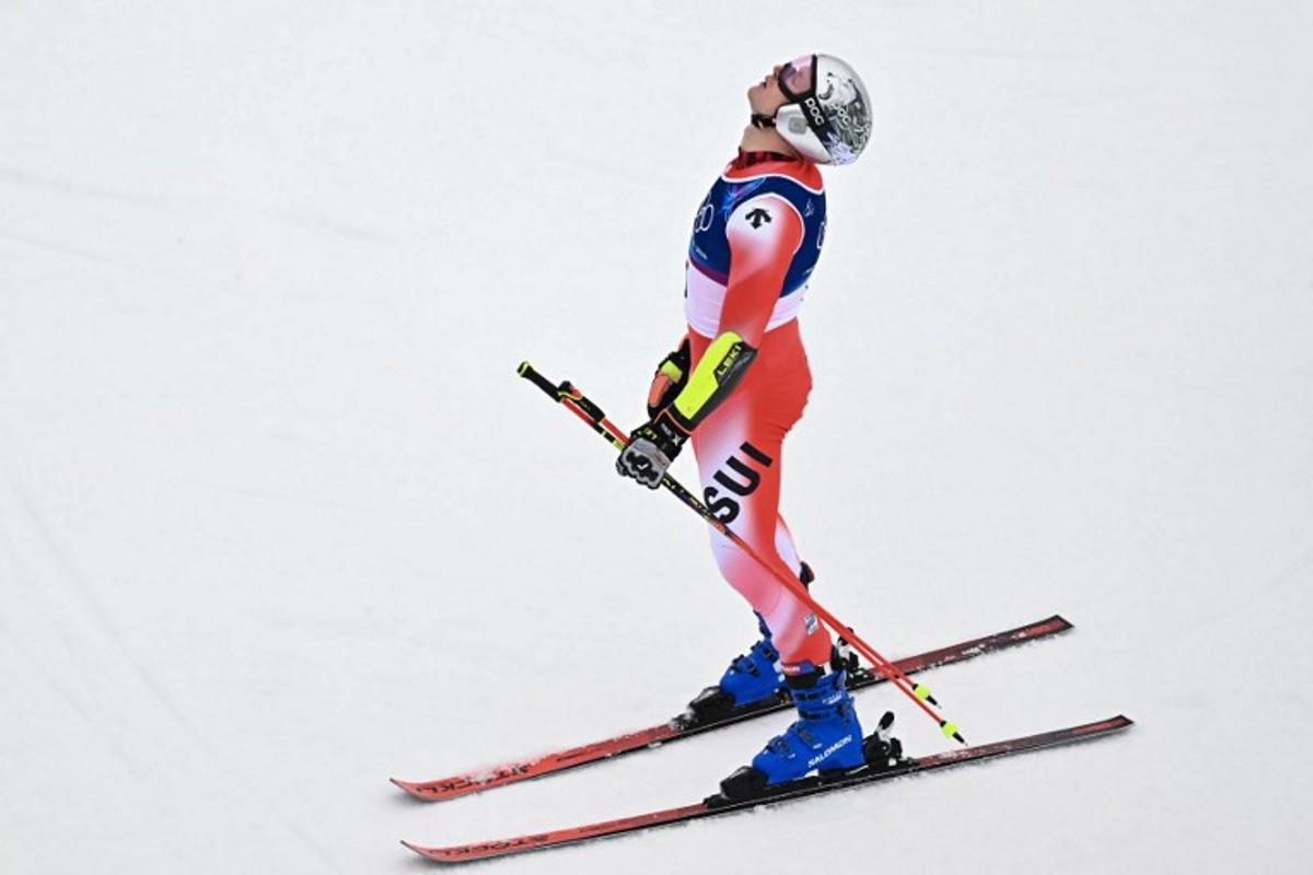 Switzerland's Marco Odermatt reacts after the second run of the men's giant slalom alpine skiing event during the Milano Cortina 2026 Winter Olympic Games at the Stelvio Ski Centre in Bormio (Valtellina) on February 14, 2026. Fabrice COFFRINI / AFP
