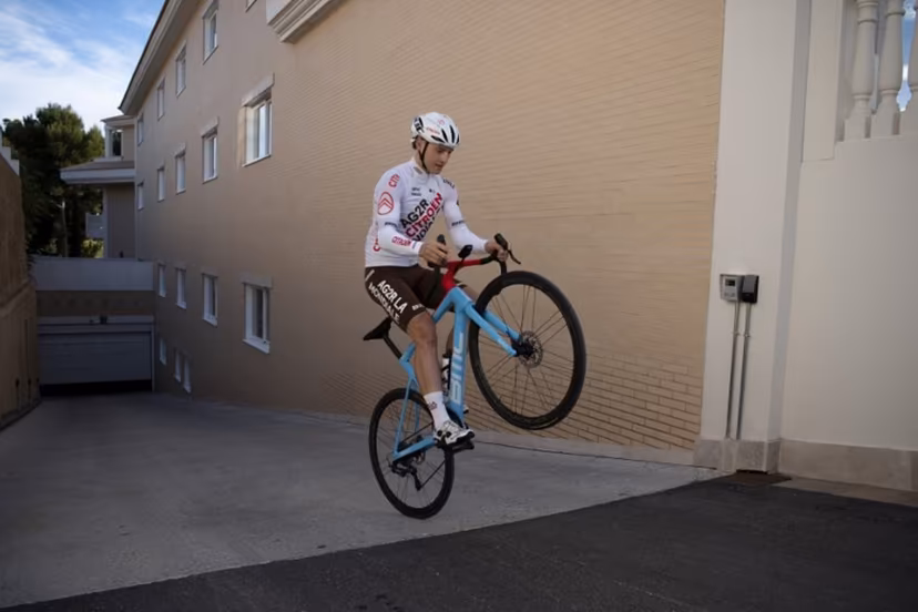 Team AG2R French cyclist Pierre Gautherat does a wheelie prior to taking part in a training session in La Nucia, near Alicante, on January 13, 2023. JORGE GUERRERO / AFP