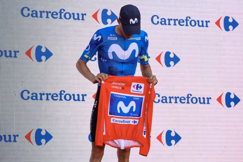 New overall race leader Team Movistar's Spanish rider Enric Mas holds the race leader's red jerse without wearing it on the podium after the eighth stage of the Vuelta a Espana 2026, a 171 km race between Pucol and Xeraco on August 29, 2026. Previous race leader Tadej Pogacar pulled out of the Vuelta a Espana on Saturday after a heavy fall 31km from the finish of a flat stage eight left him with shoulder and face injuries. Pogacar of Team UAE has won five Tour de France titles and a Giro d'Italia and was targetig his first overall victory on the Spanish 21-day race. Josep LAGO / AFP