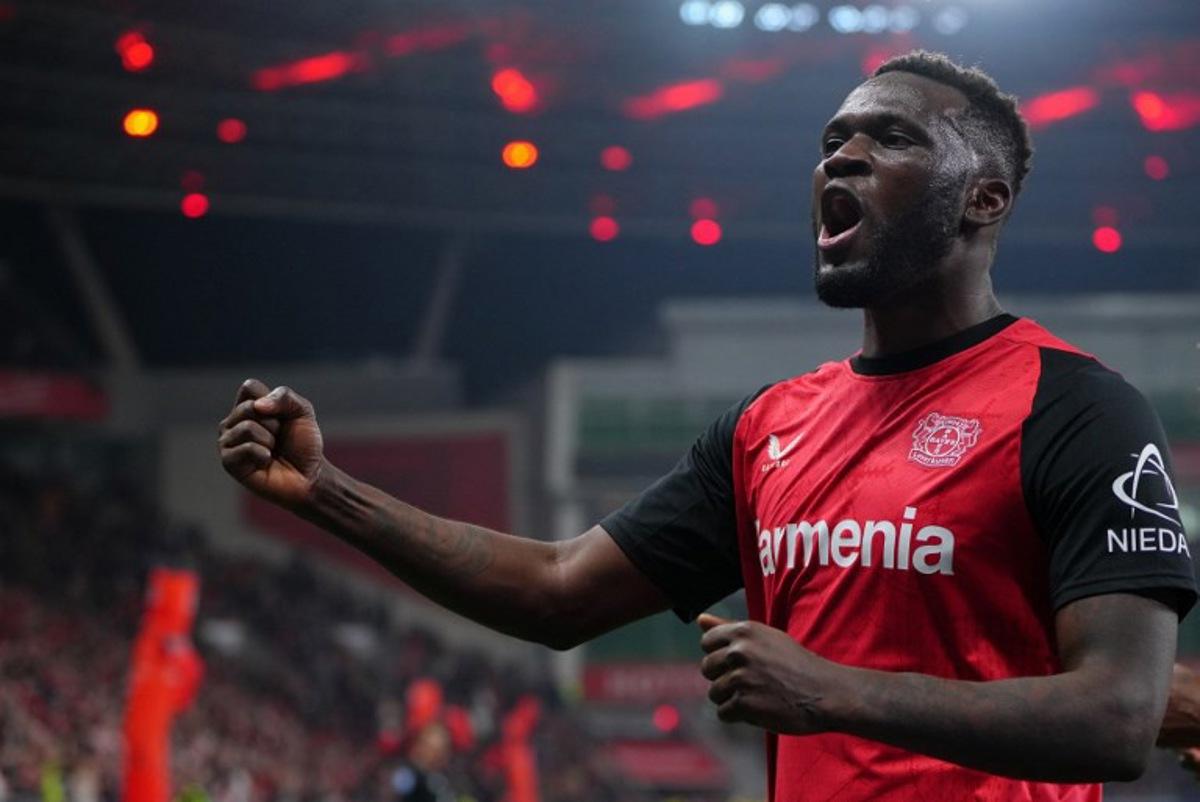 Bayer Leverkusen's Nigerian forward #22 Victor Boniface celebrates scoring the 2-1 goal with his teammates during the German first division Bundesliga football match between Bayer 04 Leverkusen and VfL Bochum in Leverkusen, western Germany on March 28, 2025. Pau BARRENA / AFP