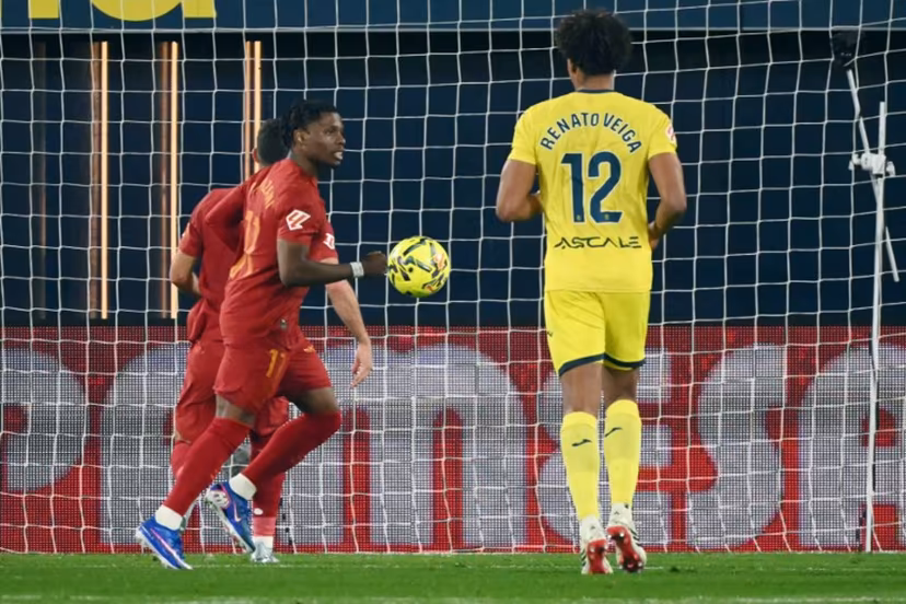 Valencia's Belgian forward # 17 Largie Ramazani celebrates after scoring the opening goal from the penalty spot during the Spanish league football match between Villarreal CF and Valencia CF at La Ceramica Stadium in Vila-real on February 22, 2026. JOSE JORDAN / AFP