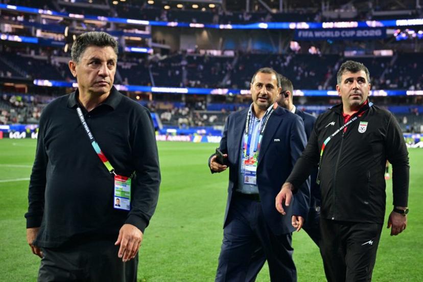 Iran's head coach Amir Ghalenoei (L) walks out the pitch after the 2026 World Cup Group G football match between Iran and New Zealand at Los Angeles Stadium in Inglewood on June 15, 2026. Frederic J. Brown / AFP