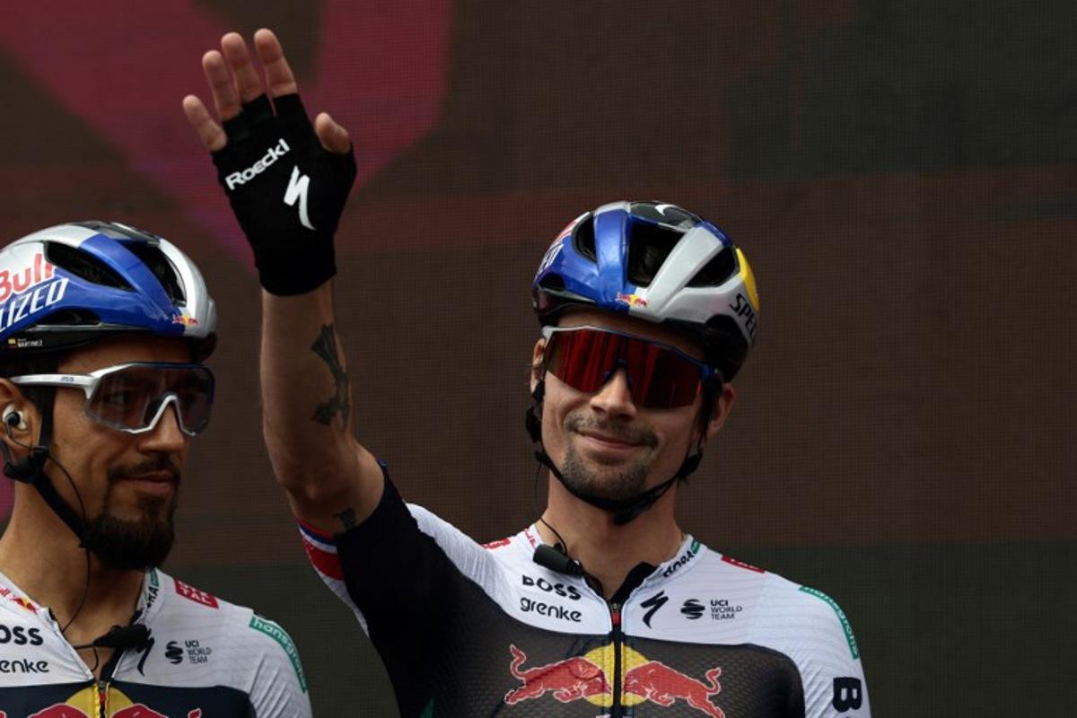 Red Bull-Bora-Hansgrohe's Slovenian rider Primoz Roglic waves during the ceremony held ahead of the start of the 9th stage of the 108th Giro d'Italia cycling race of 181kms from Gubbio to Siena on May 18, 2025. Luca Bettini / AFP