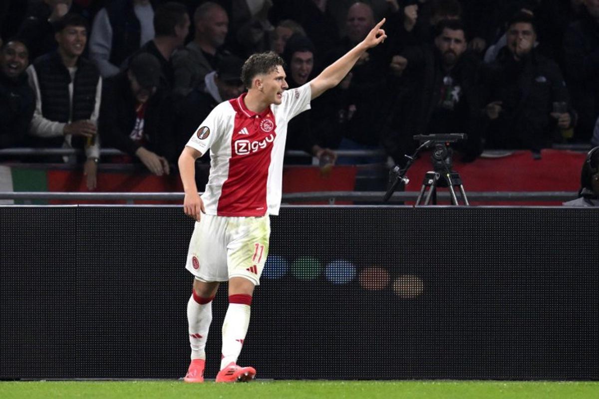 Ajax's Belgian forward #11 Mika Godts celebrates scoring his team' second goal during the UEFA Europa League football match between Ajax Amsterdam and Besiktas at The Johan Cruijff Arena Stadium in Amsterdam on September 26, 2024. JOHN THYS / AFP
