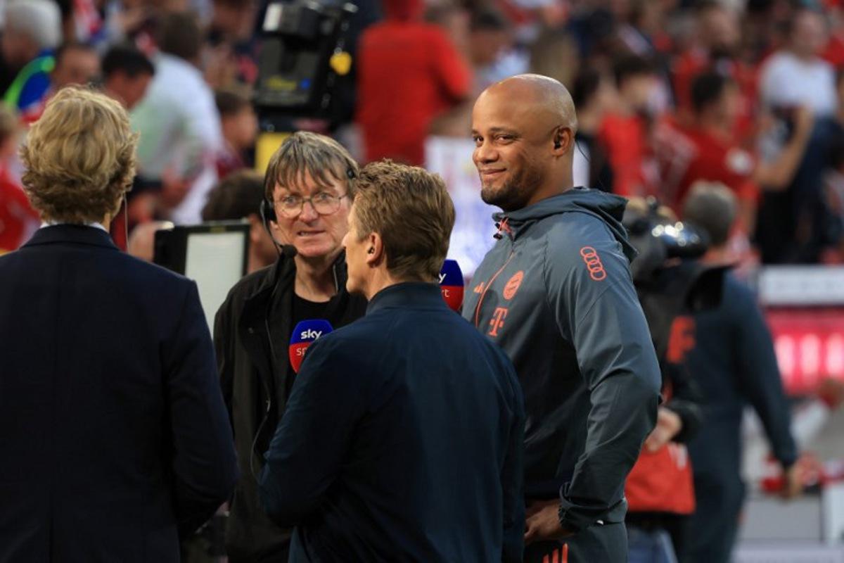 Bayern Munich's Belgian head coach Vincent Kompany (R) looks on during an interview prior to the German first division Bundesliga football match between FC Bayern Munich and RB Leipzig in Munich, southern Germany, on August 22, 2025. Karl-Josef Hildenbrand / AFP
