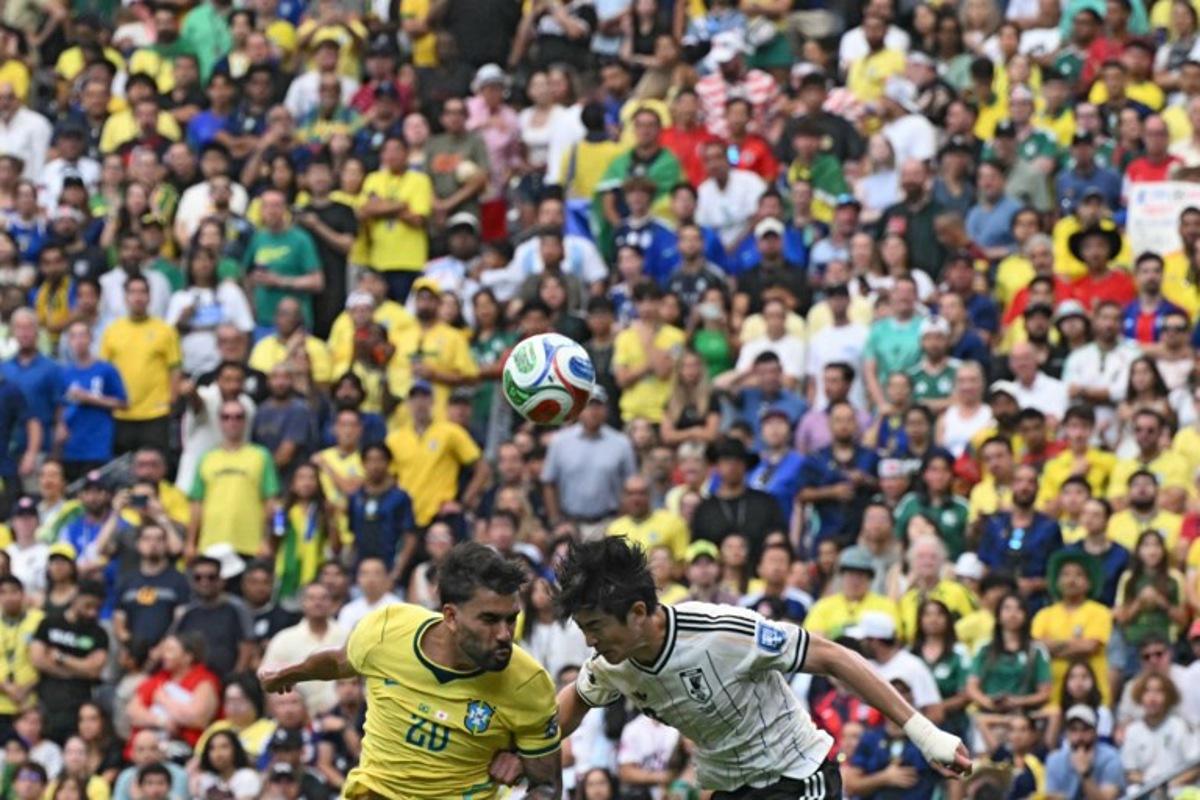 Brazil's midfielder #20 Lucas Paqueta (L) fights for the ball with Japan's defender #03 Shogo Taniguchi during the 2026 World Cup round of 32 football match between Brazil and Japan at the Houston Stadium in Houston on June 29, 2026. RONALDO SCHEMIDT / AFP
