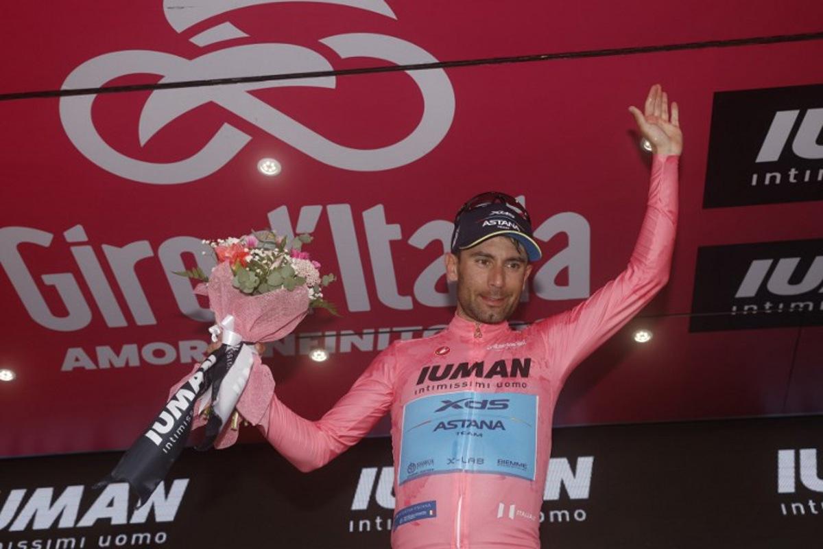 XDS Astana Team's Italian rider Diego Ulissi celebrates the Pink jersey of the overall leader on the podium after the 8th stage of the 108th Giro d'Italia cycling race of 197kms from Giulianova to Castelraimondo on May 17, 2025. Luca Bettini / AFP