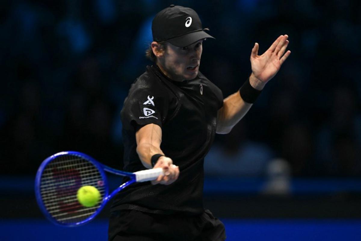 Australia's Alex De Minaur hits the ball during his match against Italy's Lorenzo Musetti at the ATP Finals tennis tournament in Turin on November 11, 2025. Marco BERTORELLO / AFP