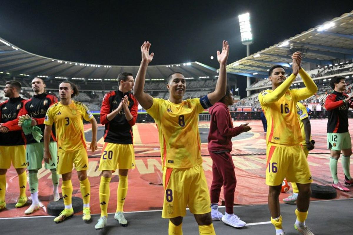 Belgium's midfielder #08 Youri Tielemans (C) celebrates with his teammates in front of Belgium fans at the end of the FIFA World Cup 2026 Group J European qualification football match between Belgium and Wales at the King Baudouin Stadium in Brussels, on June 9, 2025. NICOLAS TUCAT / AFP