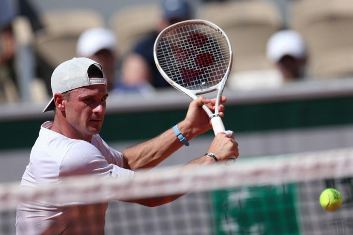 US Tommy Paul plays a backhand return to Russia's Karen Khachanov during their men's singles match on day 6 of the French Open tennis tournament on Court Simonne-Mathieu at the Roland-Garros Complex in Paris on May 30, 2025. ALAIN JOCARD / AFP