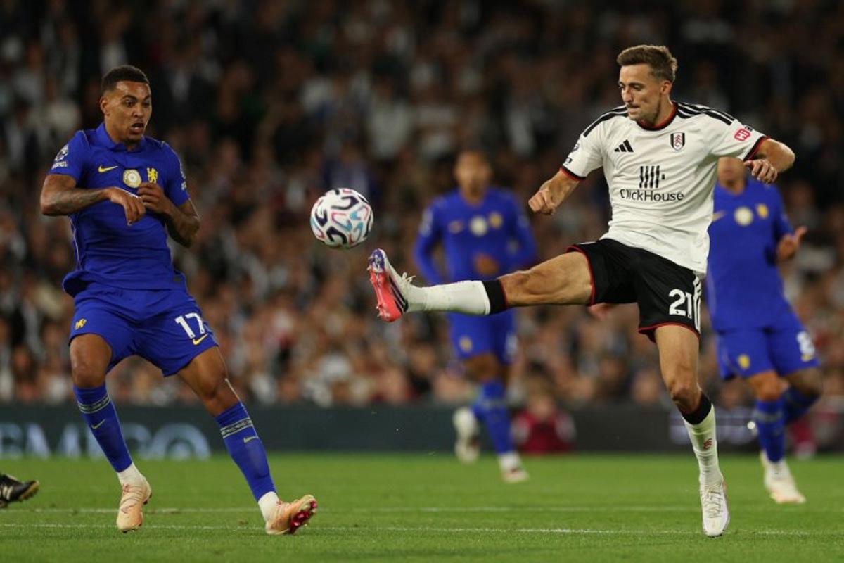 Fulham's Belgian defender #21 Timothy Castagne (R) vies with Chelsea's English midfielder #17 Morgan Rogers (L) during the English Premier League football match between Fulham and Chelsea at Craven Cottage in London on August 24, 2026. Adrian Dennis / AFP