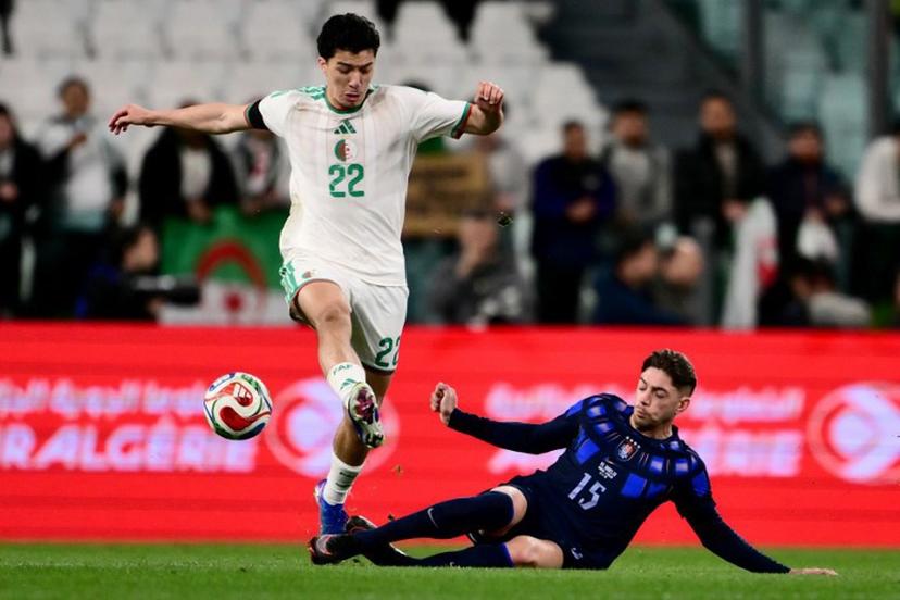 Algeria's midfielder #22 Ibrahim Maza (L) fights for the ball with Uruguay's midfielder #15 Federico Valverde (R) during the friendly international football match between Algeria and Uruguay at the Allianz Stadium in Turin on March 31, 2026. MARCO BERTORELLO / AFP