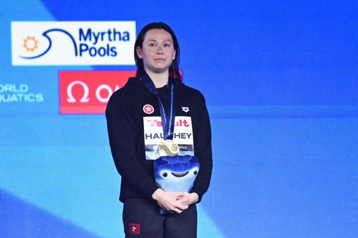 Hong Kong's gold-medallist Siobhan Bernadette Haughey poses on the podium of the women's 200m freestyle swimming event during the 2024 World Aquatics Championships at Aspire Dome in Doha on February 14, 2024. Oli SCARFF / AFP