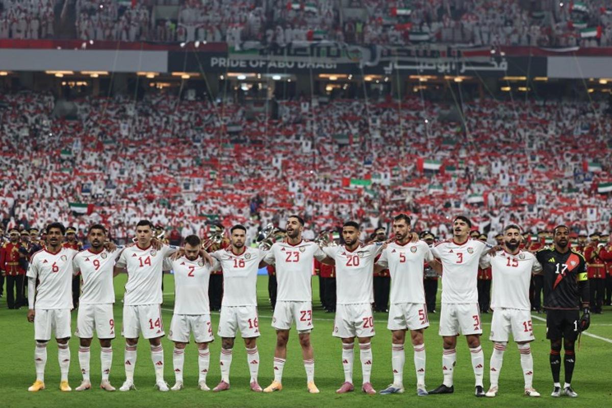 UAE players stand for their national anthem ahead of the FIFA World Cup 2026 Asian qualifier football match between the United Arab Emirates and Iraq at the Mohammed bin Zayed Stadium in Abu Dhabi on November 13, 2025. Fadel SENNA / AFP