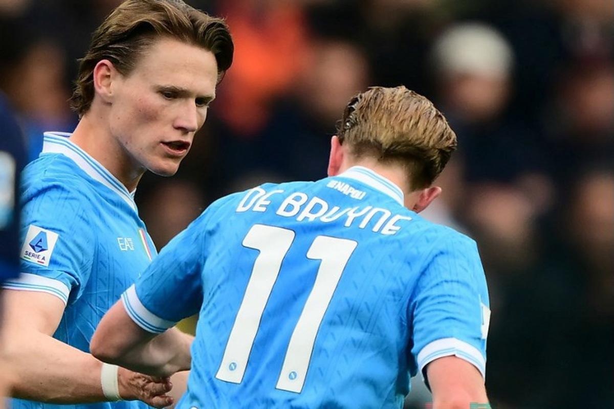 Napoli's Scottish midfielder #08 Scott McTominay celebrates with Napoli's Belgian midfielder #11 Kevin De Bruyne after scoring a goal during the Italian Serie A football match between Parma Calcio 1913 and SSC Napoli at the Ennio Tardini Stadium in Parma on April 12, 2026. MARCO BERTORELLO / AFP