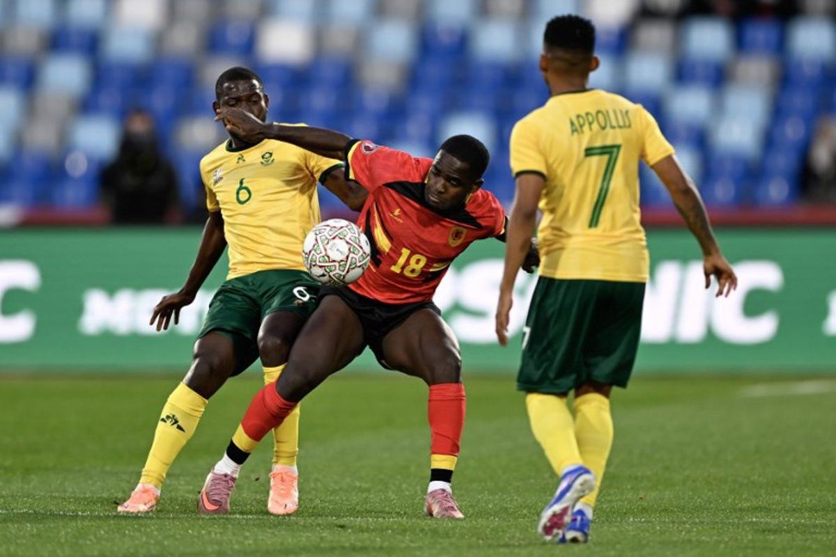 Angola's forward #18 Zito Luvumbo (C) fights for the ball with South Africa's defender #06 Aubrey Modiba (L) during the Africa Cup of Nations (CAN) Group B football match between South Africa and Angola at Marrakesh Stadium in Marrakesh, Morocco on December 22, 2025. Khaled DESOUKI / AFP