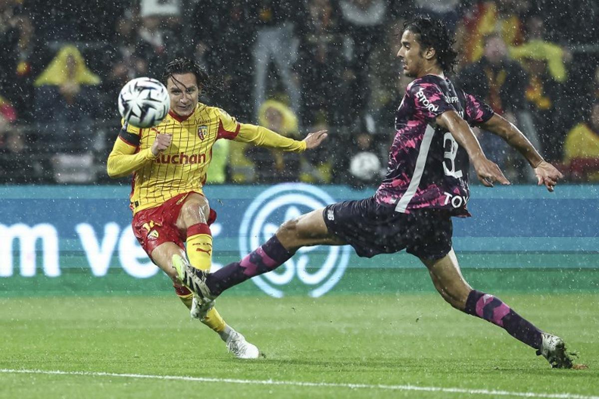 Lens' French forward #10 Florian Thauvin (L) kicks the ball and scores his team's second goal during the French L1 football match between RC Lens and Lille LOSC at the Stade Bollaert-Delelis in Lens, northern France, on September 20, 2025. Sameer Al-DOUMY / AFP