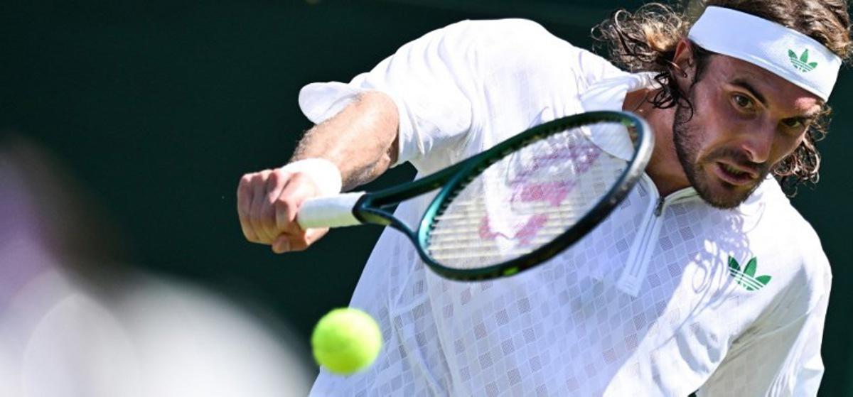 Greece's Stefanos Tsitsipas plays a backhand return to France's Valentin Royer during their men's singles first round tennis match on the first day of the 2025 Wimbledon Championships at The All England Lawn Tennis and Croquet Club in Wimbledon, southwest London, on June 30, 2025. Kirill KUDRYAVTSEV / AFP