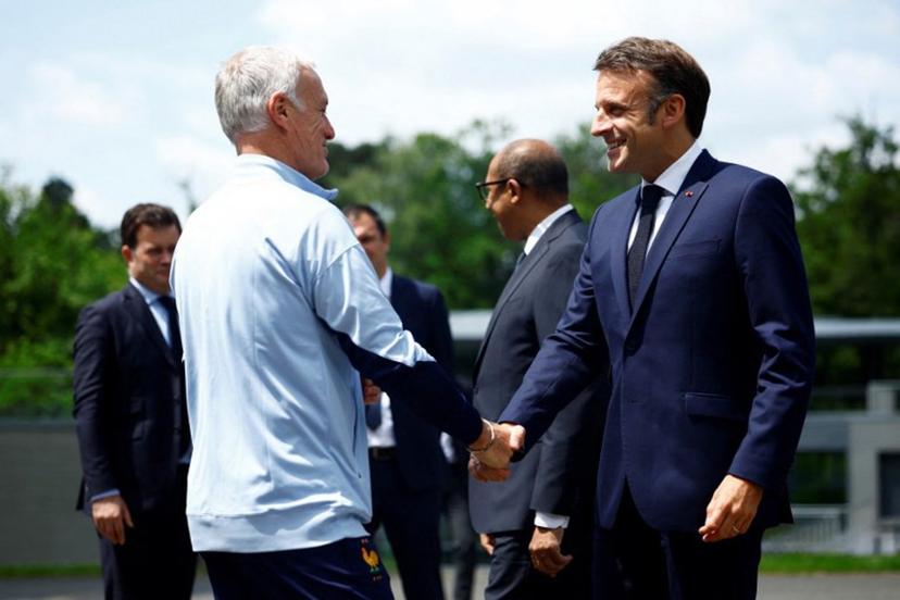 French President Emmanuel Macron (R) shakes hands with French headcoach Didier Deschamps as he arrives for a lunch at the team's training camp, as part of the team's preparation for the UEFA Euro 2024 European football championships in Clairefontaine-en-Yvelines on June 3, 2024. Sarah Meyssonnier / POOL / AFP