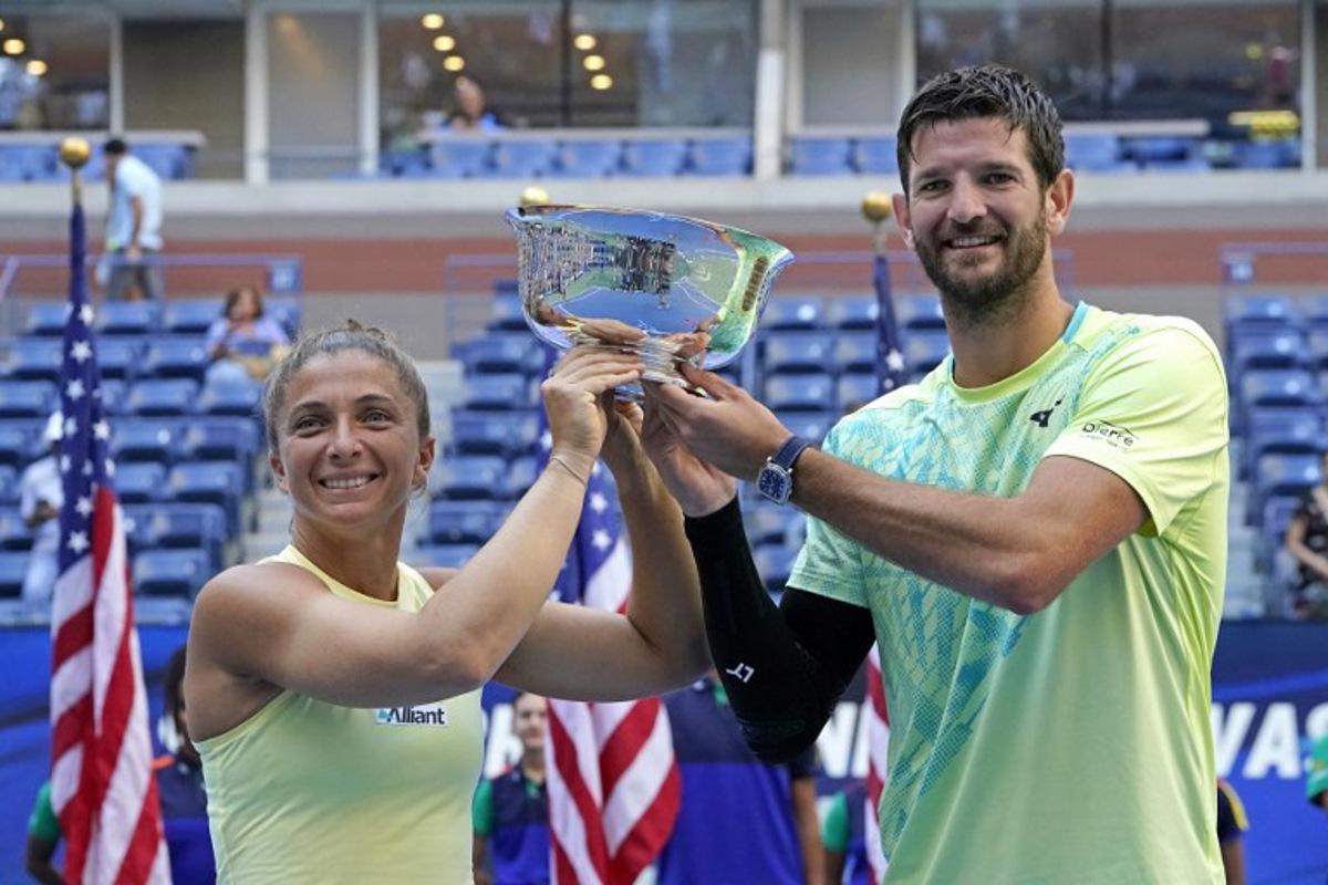 Italy's Sara Errani (L) and Andrea Vavassori celebrate with the trophy after defeating USA's Taylor Townsend and Donald Young play in their mixed doubles final match on day eleven of the US Open tennis tournament at the USTA Billie Jean King National Tennis Center in New York City, on September 5, 2024. TIMOTHY A. CLARY / AFP