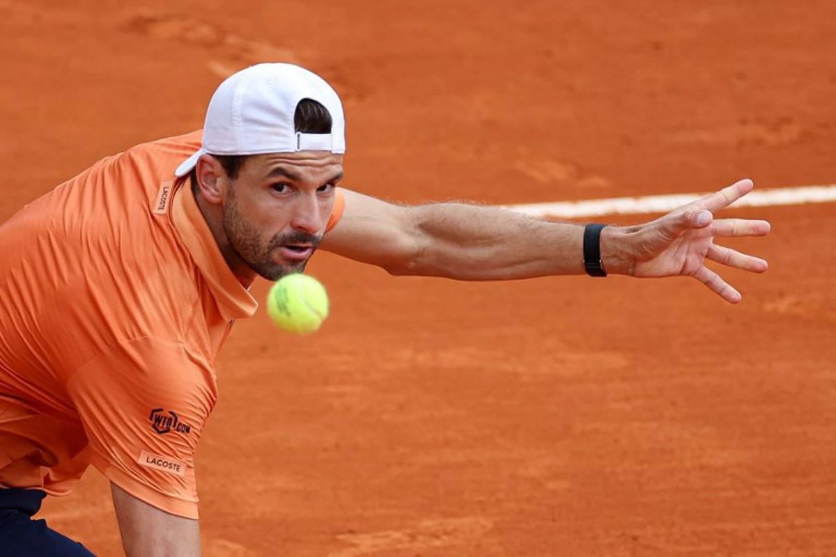 Bulgaria's Grigor Dimitrov eyes the ball as he plays against Argentina's Tomas Martin Etcheverry during the Monte Carlo ATP Masters Series Tournament round of 64 tennis match on Court des Princes at the Monte-Carlo Country Club in Roquebrune-Cap-Martin, south-eastern France on April 7, 2026. Valery HACHE / AFP