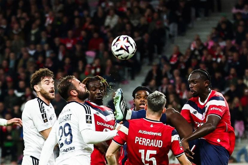 Lille's French defender #23 Tanguy Nianzou (R) shoots the ball during the French L1 football match between Lille LOSC and Stade Brestois 29 (Brest) at the Stade Pierre-Mauroy in Villeneuve-d'Ascq, northern France, on October 17, 2026. Sameer AL-DOUMY / AFP