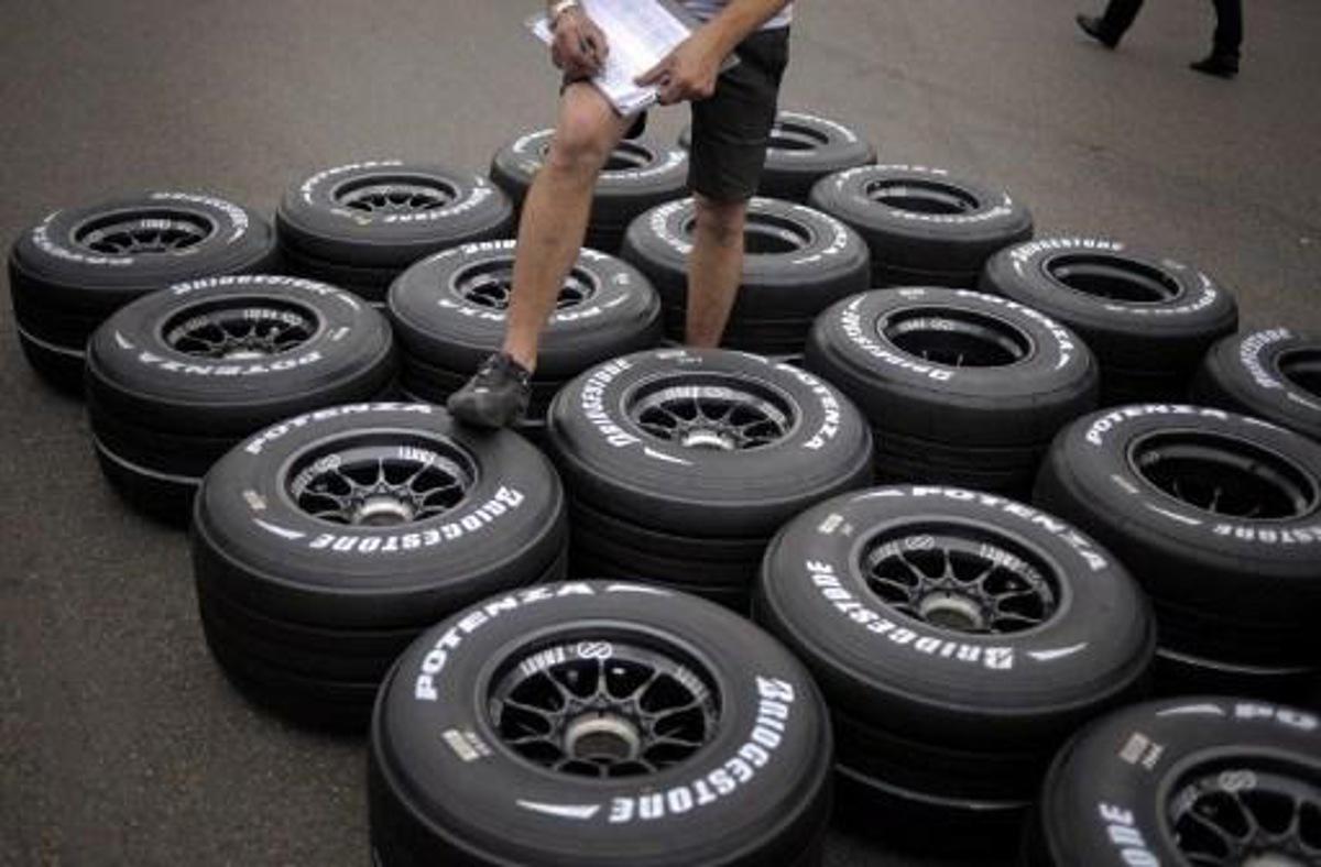 A technician cheks tires in the paddock of the Magny-Cours racetrack on June 19, 2008 in Magny-Cours, central France, three days ahead of the French Formula One Grand Prix. AFP PHOTO / JEFF PACHOUD