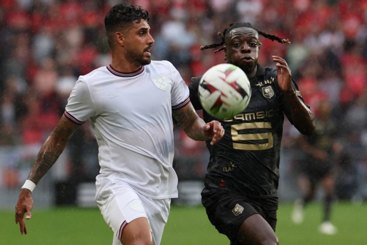 Rennes' Belgian forward Jeremy Doku (R) fights for the ball with West Ham United's Italian defender Emerson Palmieri during the pre-season friendly football match between Rennes and West Ham United FC at the Roazhon Park stadium in Rennes, western France, on July 29, 2023. Fred TANNEAU / AFP