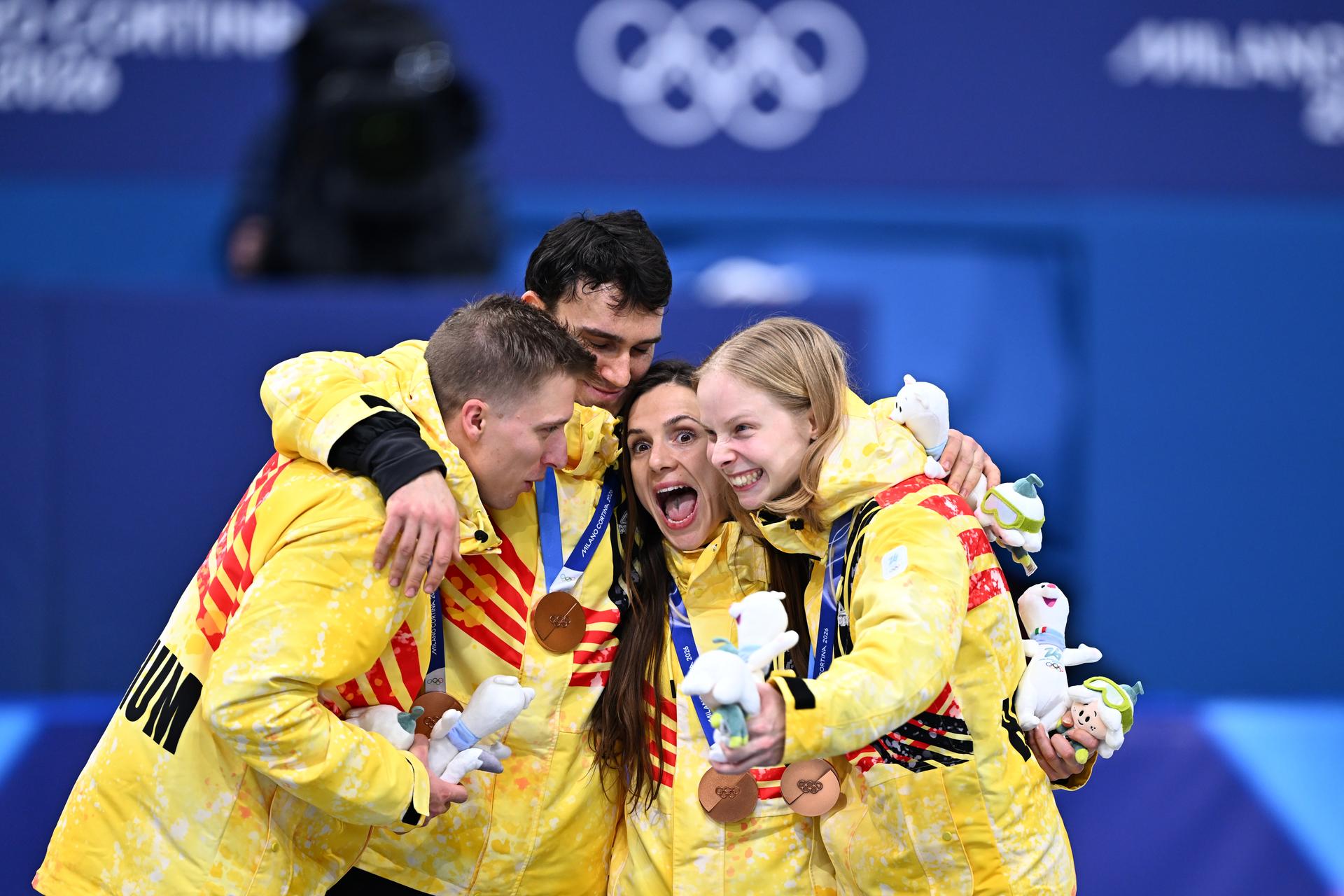 Belgian shorttrack skater Ward Petre, Belgian shorttrack skater Stijn Desmet, Belgian shorttrack skater Hanne Desmet and Belgian shorttrack skater Tineke den Dulk celebrate their bronze medal on the podium of the Mixed Team Relay of the Short Track Speed Skating competition at the Milano Cortina 2026 Olympic Winter Games, on Tuesday 10 February 2026 in Milan, Italy. The XXV Winter Olympics take place from 6 to 22 February 2026 in Italy. BELGA PHOTO JASPER JACOBS